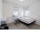 Bright bedroom with two windows, neutral carpet, a full bed and functional study area at 9001 Fitzgerald Dr, Indianapolis, IN 46239
