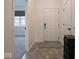 A well-lit entryway with tile floors and a white front door at 9001 Fitzgerald Dr, Indianapolis, IN 46239