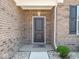 A charming brick home exterior featuring a welcoming front door at 9001 Fitzgerald Dr, Indianapolis, IN 46239