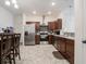 Well-lit kitchen features stainless steel appliances, dark wood cabinets, and tile flooring at 9001 Fitzgerald Dr, Indianapolis, IN 46239