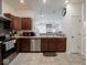Well-lit kitchen features stainless steel appliances, dark wood cabinets, and tile flooring at 9001 Fitzgerald Dr, Indianapolis, IN 46239