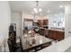 Well-lit kitchen and dining area features stainless steel appliances and dark wood cabinets at 9001 Fitzgerald Dr, Indianapolis, IN 46239