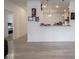 Bright kitchen view with a breakfast bar that connects it to the living area, modern lighting, and light grey flooring at 9001 Fitzgerald Dr, Indianapolis, IN 46239