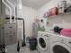Functional laundry room with washer, dryer, and shelving for storage at 9001 Fitzgerald Dr, Indianapolis, IN 46239