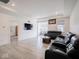 Bright living room featuring recessed lighting, a black leather sofa, and wood floors at 9001 Fitzgerald Dr, Indianapolis, IN 46239