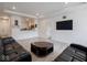 Bright living room featuring recessed lighting, wood floors, and black leather sofas at 9001 Fitzgerald Dr, Indianapolis, IN 46239