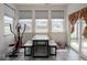 Cozy sunroom with abundant natural light from large windows, featuring a dining area and workout equipment at 9001 Fitzgerald Dr, Indianapolis, IN 46239