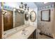 Bathroom featuring a vanity with dual mirrors, floral wallpaper, and vinyl flooring at 9133 Log Run N Dr, Indianapolis, IN 46234