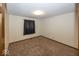 Neutral bedroom featuring carpeted floors, a window with a curtain, and overhead lighting at 9133 Log Run N Dr, Indianapolis, IN 46234
