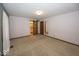 Spacious bedroom with carpeted floors, neutral color palette, closet and decorative wood door at 9133 Log Run N Dr, Indianapolis, IN 46234
