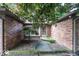Inviting front entrance featuring a decorative tree, brick facade, and a charming covered entryway at 9133 Log Run N Dr, Indianapolis, IN 46234