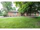 Charming brick home featuring lush green lawn and mature trees, nestled on a well-manicured lot at 9133 Log Run N Dr, Indianapolis, IN 46234