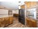 Traditional kitchen with wood cabinets, granite countertops, brick accents and stainless steel appliances at 9133 Log Run N Dr, Indianapolis, IN 46234