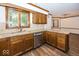 Kitchen with wooden cabinets, granite countertops, stainless steel appliances and hardwood flooring at 9133 Log Run N Dr, Indianapolis, IN 46234