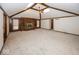 Large living room with vaulted ceilings, a fireplace, built-in bookshelves, and ample space for entertaining at 9133 Log Run N Dr, Indianapolis, IN 46234