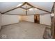 Bright living room featuring vaulted ceilings, wood beams, a cozy brick fireplace, and large open space at 9133 Log Run N Dr, Indianapolis, IN 46234