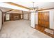 Open-concept living room showcasing fireplace, built-in shelving, natural light, and elegant wood and carpet flooring at 9133 Log Run N Dr, Indianapolis, IN 46234