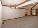 Spacious living room with vaulted ceilings, wood trim detail, and neutral carpet creating a warm, inviting space at 9133 Log Run N Dr, Indianapolis, IN 46234
