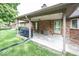 Covered patio area with brick columns, outdoor lighting, and a view of the backyard at 9133 Log Run N Dr, Indianapolis, IN 46234