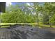 Spacious backyard with mature trees and a stained wood deck at 9148 Oak Knoll Ln, Fishers, IN 46037