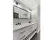 Contemporary bathroom featuring dual sinks, white cabinetry, and modern fixtures at 9148 Oak Knoll Ln, Fishers, IN 46037