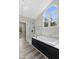 Luxurious bathroom featuring a large soaking tub, glass shower, and arched window at 9148 Oak Knoll Ln, Fishers, IN 46037