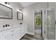 Bathroom featuring dual sinks, white cabinets, and a glass enclosed shower at 9148 Oak Knoll Ln, Fishers, IN 46037