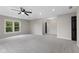 Large bedroom with a ceiling fan, carpet and views from the plentiful windows overlooking the backyard at 9148 Oak Knoll Ln, Fishers, IN 46037