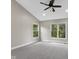 Bright bedroom with carpeted floor, ceiling fan and large windows overlooking green trees at 9148 Oak Knoll Ln, Fishers, IN 46037