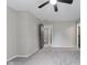 Large bedroom with an entry door, grey paint, ceiling fan, and carpet floors at 9148 Oak Knoll Ln, Fishers, IN 46037