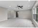 Spacious room features neutral walls, carpet, a ceiling fan, and multiple windows for natural light at 9148 Oak Knoll Ln, Fishers, IN 46037