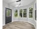 Sunny breakfast nook with large windows overlooking the backyard and a modern light fixture at 9148 Oak Knoll Ln, Fishers, IN 46037