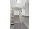 Walk-in closet with built-in shelving and hanging rods at 9148 Oak Knoll Ln, Fishers, IN 46037