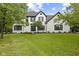 Charming two-story home features a white brick exterior and a lush, green lawn at 9148 Oak Knoll Ln, Fishers, IN 46037