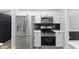 Well-equipped kitchen features stainless steel appliances and white cabinets at 9148 Oak Knoll Ln, Fishers, IN 46037