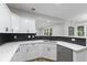 Modern kitchen with white cabinets, sleek countertops, and stainless steel appliances at 9148 Oak Knoll Ln, Fishers, IN 46037