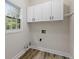 Bright laundry room with white cabinets, and hardwood floors; a convenient space for laundry tasks at 9148 Oak Knoll Ln, Fishers, IN 46037