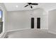 Spacious main bedroom with a ceiling fan, black doors, and large windows for plenty of natural light at 9148 Oak Knoll Ln, Fishers, IN 46037