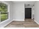 The light-filled room features light grey walls, wood-look floors, and a window overlooking the backyard at 9148 Oak Knoll Ln, Fishers, IN 46037