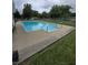 Inviting in-ground pool with clear water, surrounded by concrete and greenery at 9984 W Sunset Ln, Elwood, IN 46036