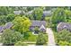 Aerial view of a beautiful brick home with a well-manicured lawn and mature trees in a suburban setting at 10717 Windermere Blvd, Fishers, IN 46037