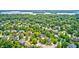 Expansive aerial view showcasing a neighborhood surrounded by mature trees, with glimpses of a serene lake in the distance at 10717 Windermere Blvd, Fishers, IN 46037