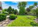 Lush backyard with a play area, mature trees, and a wooden deck for outdoor enjoyment at 10717 Windermere Blvd, Fishers, IN 46037