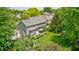 Aerial view of a well-maintained backyard with a patio, mature trees, a landscaped lawn, and a play area at 10717 Windermere Blvd, Fishers, IN 46037