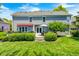 Spacious backyard showcasing a large deck with dining and seating, a lawn, and the home's exterior at 10717 Windermere Blvd, Fishers, IN 46037