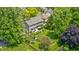 Aerial view of a private backyard with a patio, manicured lawn, mature trees, and play area perfect for outdoor fun at 10717 Windermere Blvd, Fishers, IN 46037