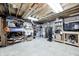 Unfinished basement featuring utility systems and storage shelving on a concrete floor with an exposed ceiling at 10717 Windermere Blvd, Fishers, IN 46037