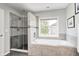 This bathroom showcases a soaking tub, tiled shower, and a bright window with natural light at 10717 Windermere Blvd, Fishers, IN 46037