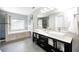 This bathroom showcases a dual sink vanity, a soaking tub, and modern finishes throughout at 10717 Windermere Blvd, Fishers, IN 46037