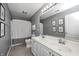 Bathroom featuring a double sink vanity, a large mirror, and a shower/tub combo with a white curtain at 10717 Windermere Blvd, Fishers, IN 46037